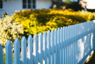 about-02 a-white-picket-fence-in-front-of-a-house-zyudugddadm